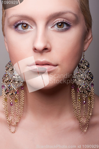 Image of attractive girl portrait wiht ethnic earring