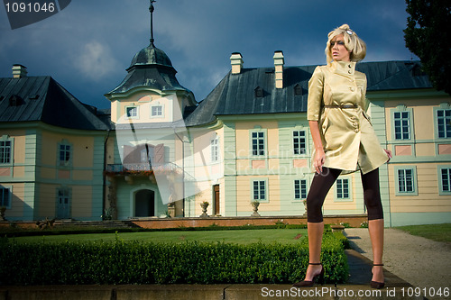 Image of attractive blonde girl in castle park