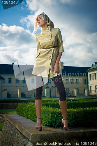 Image of attractive fashion blond girl in castle park