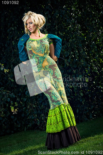 Image of attractive fashion blond girl in park
