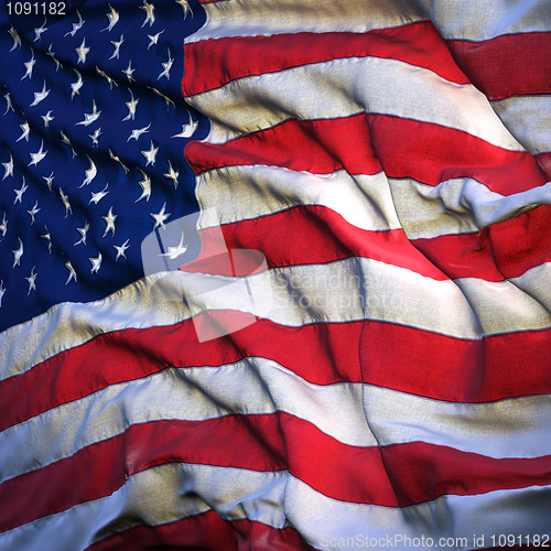 Image of Flag of the United States, fluttering in the breeze, backlit ris