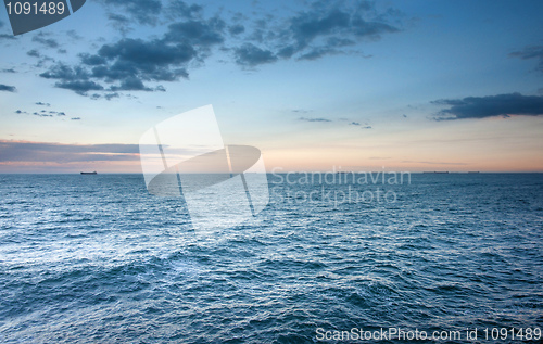 Image of ocean waves at sunset