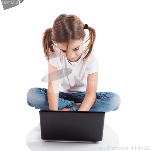 Image of Little student girl with a laptop