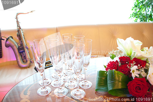 Image of Flowers, glasses and saxophone