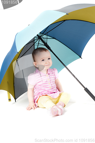 Image of Cute baby girl under umbrella