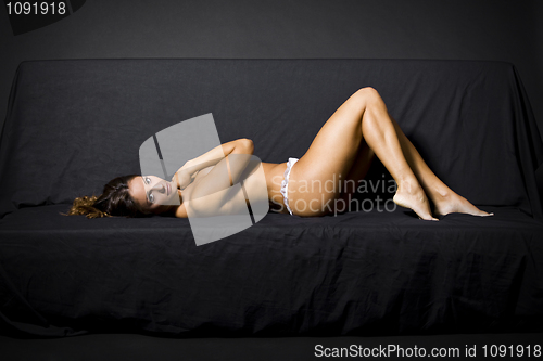 Image of topless woman in bed