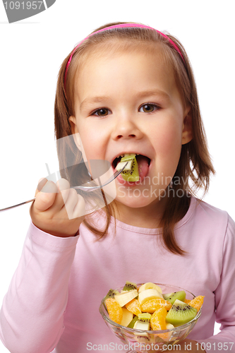 Image of Little girl eats fruit salad