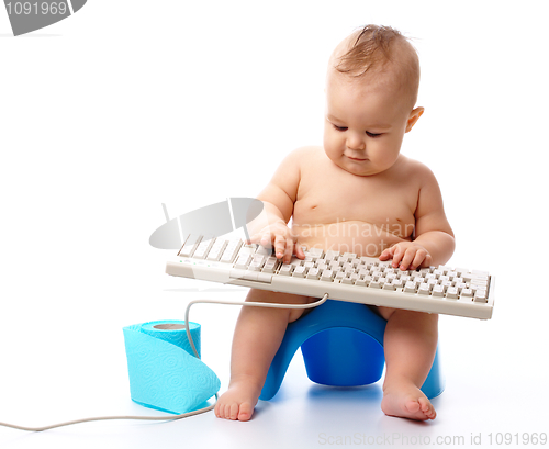 Image of Little child is typing on keyboard