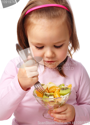 Image of Little girl eats fruit salad