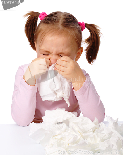 Image of Little girl blows her nose