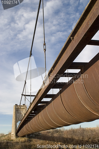 Image of Old rusty aqueduct across a river