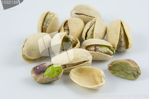Image of dozen of salted and roasted pistachio nuts