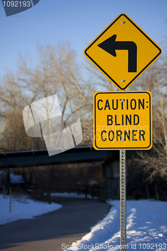 Image of Blind corner turning warning sign on biking trail