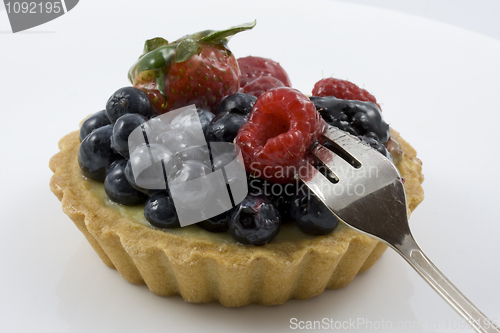 Image of eating a tart with mixed berries