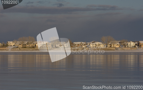 Image of skyline of Colorado houses across frozen lake