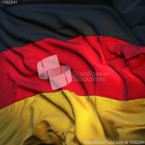 Image of Flag of Germany, fluttering in the breeze, backlit rising sun