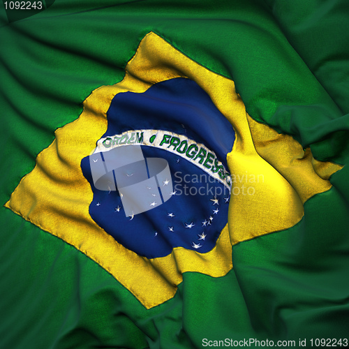 Image of Flag of Brazil, fluttering in the breeze, backlit rising sun