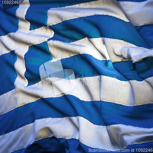 Image of Flag of Greece, fluttering in the breeze, backlit rising sun