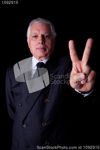 Image of businessman with thumb raised as a sign victory