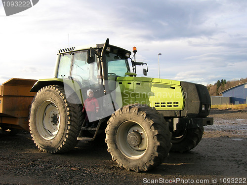 Image of Small kid, big tractor