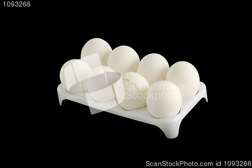 Image of Eight white eggs with one cracked in carton