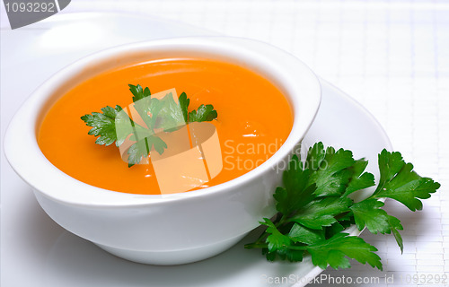 Image of Pumpkin soup in white bowl  with parsley