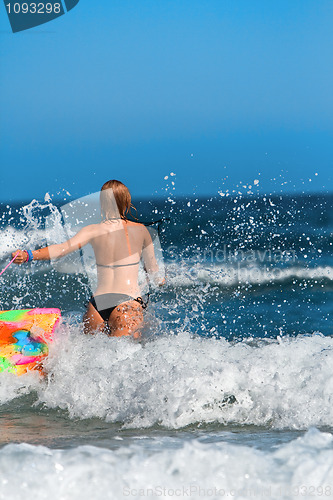 Image of Woman running in the sea 