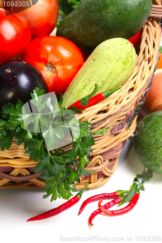 Image of basket with vegetables isolated on white 