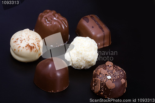 Image of Delicious chocolates on black background 