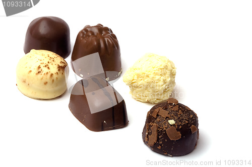 Image of chocolate truffle in white background - focus on first 