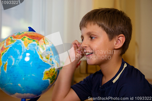 Image of boy looking globe of world 