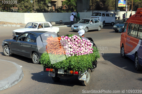 Image of Egyptian peasant carries carrots and radishes