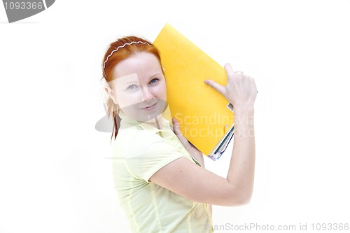 Image of redhead young woman student holding a notebooks