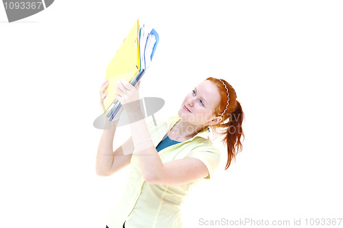 Image of redhead young woman student holding a notebooks