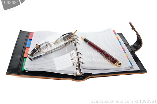 Image of Planner, pen and eyeglasses isolated on white background