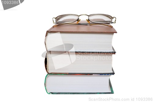 Image of Eyeglasses on the books isolated on white