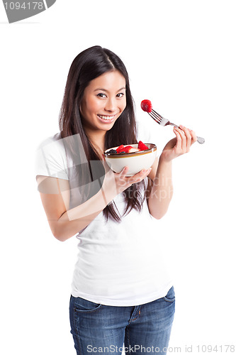 Image of Asian woman eating fruit