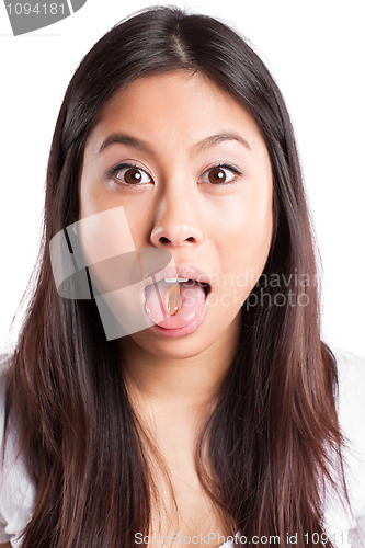 Image of Asian woman taking fish oil