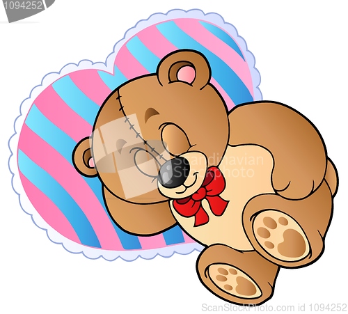 Image of Teddy bear on heart shaped pillow