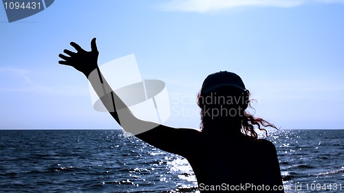 Image of Silhouette of woman against the sea