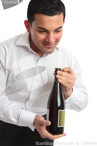 Image of Waiter presenting bottle of wine