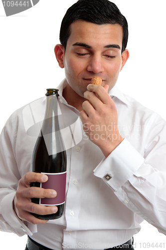 Image of Man sniffing wine cork