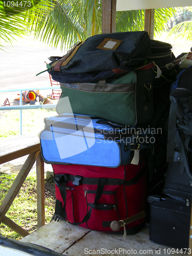 Image of luggage in cart at airport with palm trees Corn Island Nicaragua