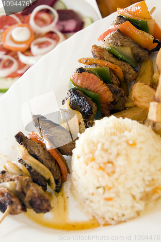 Image of beef shish kabob on skewer with rice Nicaragua