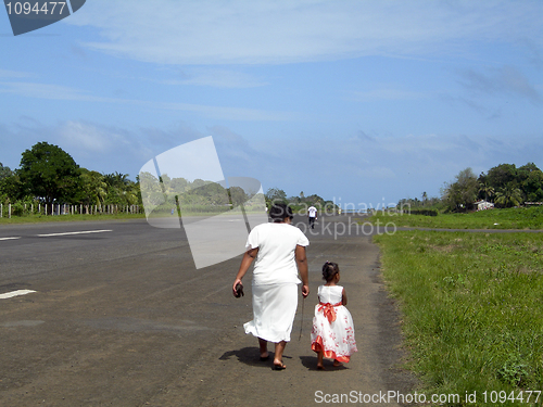 Image of mother daughter walking of airport runway Corn Island Nicaragua