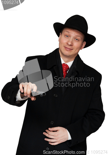 Image of man in a black coat and hat
