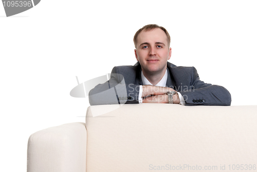 Image of businessman looking out over the sofa