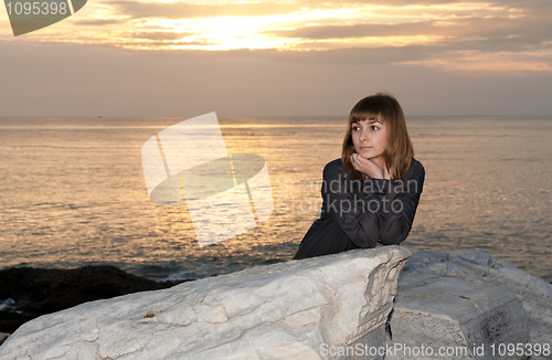 Image of girl against the sea at night