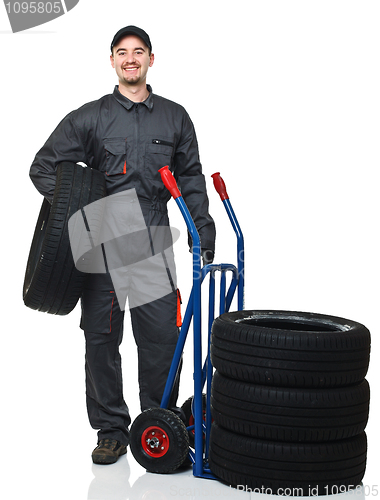 Image of man with handtruck and tires