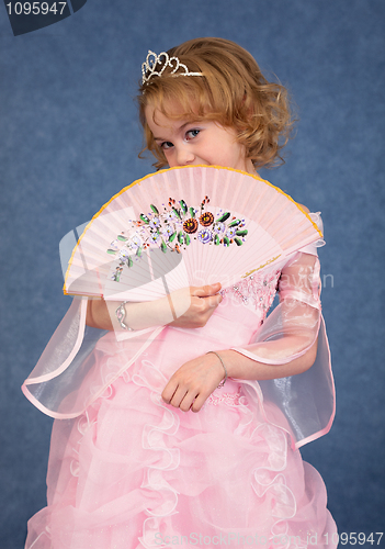 Image of Beautiful little girl in pink dress with a fan